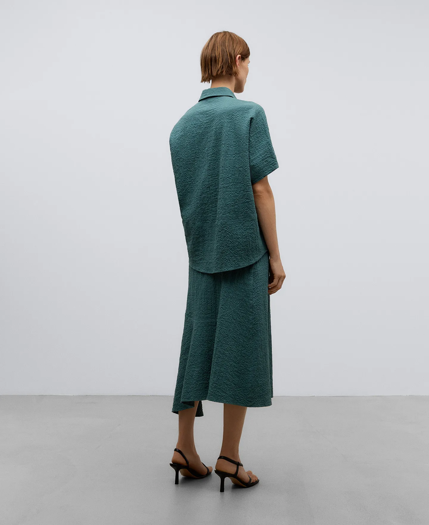 Green cotton asymmetric skirt woman